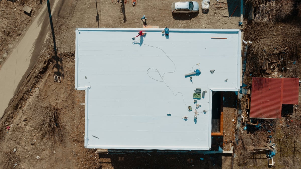 Flat roof under construction on a residential building with a waterproof membrane