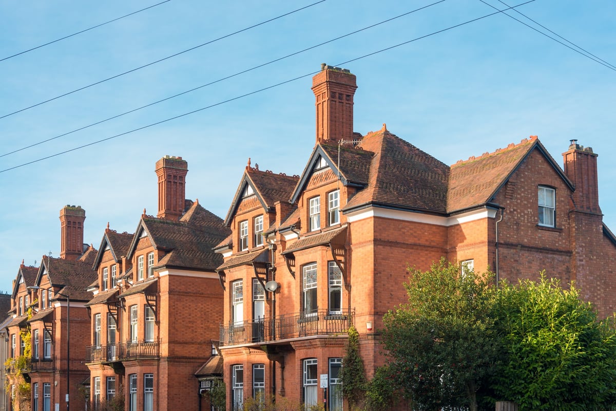 Late Victorian red brick townhouses with pitched roofs and chimneys in central England