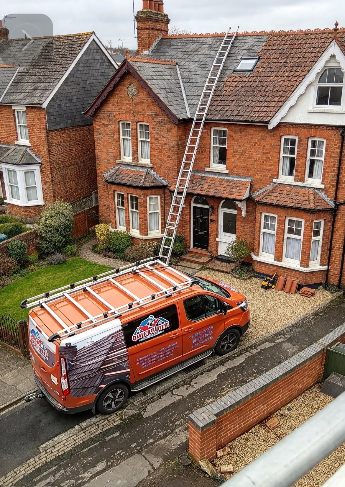Orange service van with roof ladder parked in driveway of large brick Victorian house